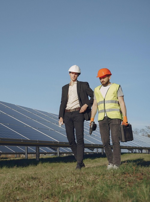 A picture of installers walking next to solar panels