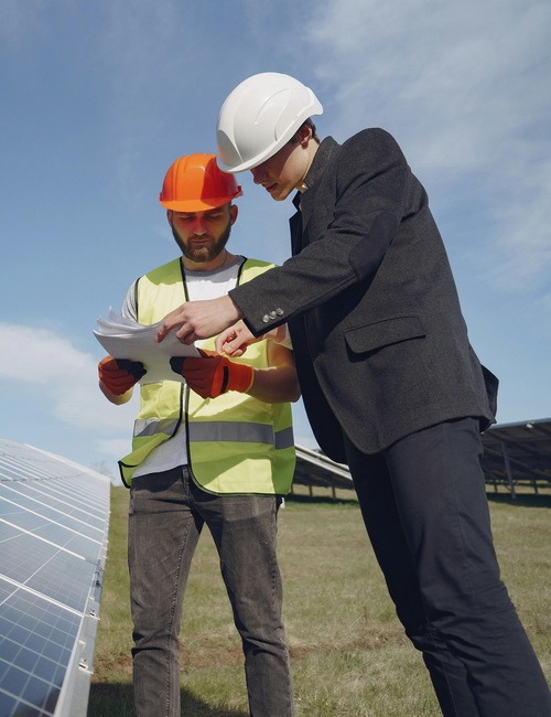 Two men checking a solar power installation project