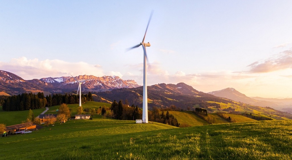 A picture of two wind turbines in a field